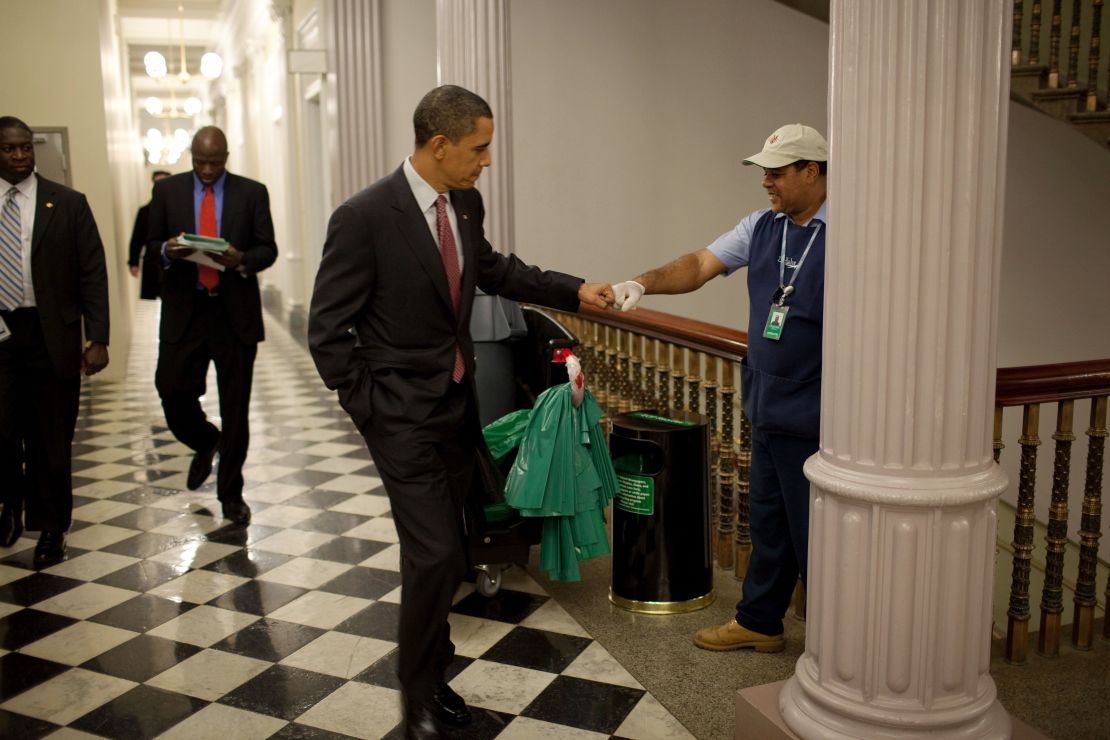 President Obama fist-bumps custodian Lawrence Lipscomb in the Eisenhower Executive Office Building.